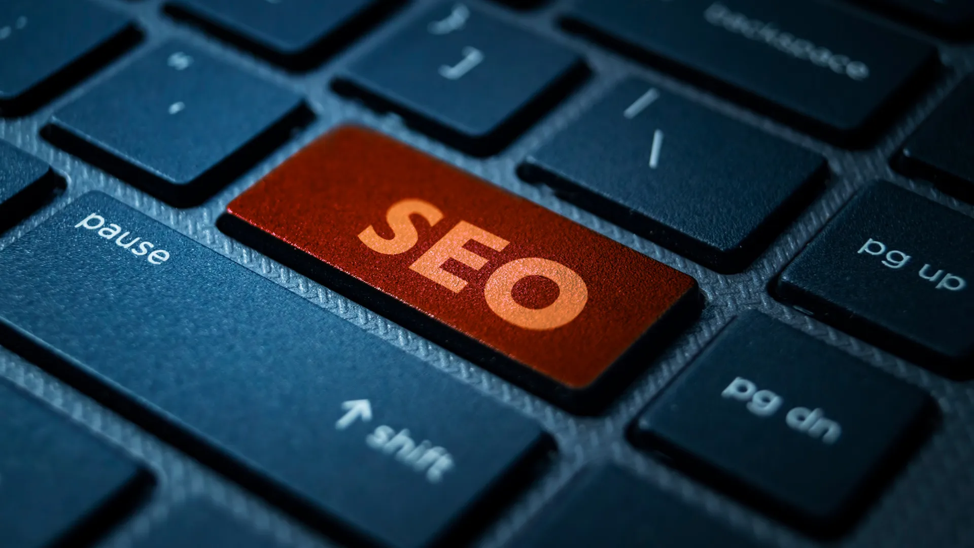 A close-up of an SEO button on a keyboard, emphasizing the importance of SEO for construction companies to improve online presence.